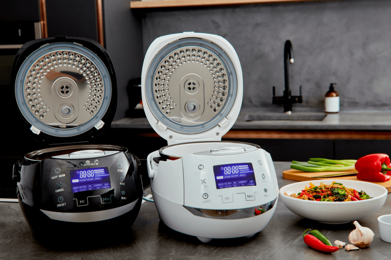 Yum Asia Sakura rice cookers in white nd black colours showing stainless steel inner lids