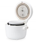 Fuji UMAI IH rice cooker on right side with lid open
