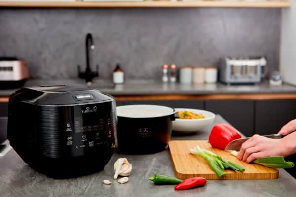 Yum Asia Bamboo UMAI IH Rice Cooker (anthracite black) on table with food prepared