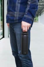 Iku Active black thermal vacuum flask being carried