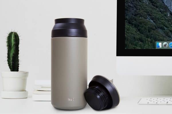 Iku green thermal vacuum flask on table