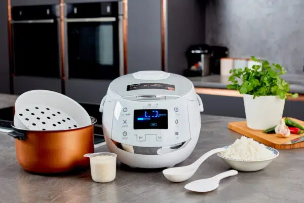 White Sakura rice cooker on table with accessories